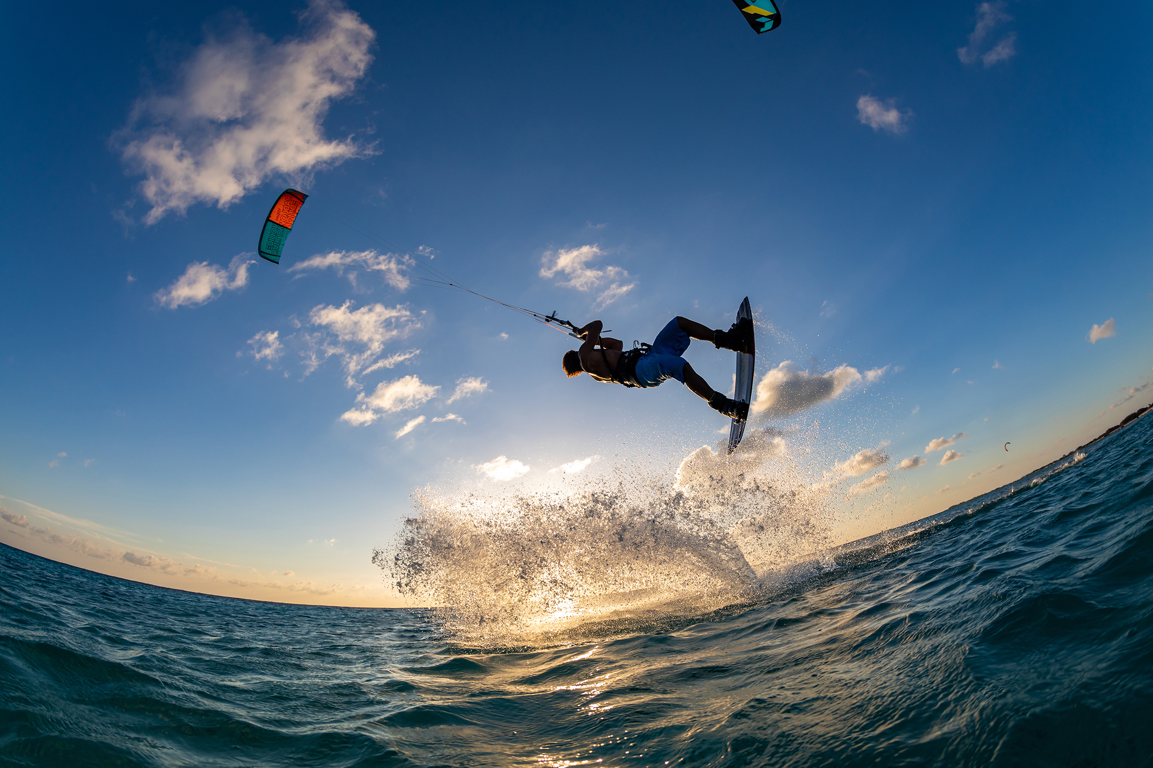 person surfing and flying a parachute at the same time in kitesurfing bonaire caribbean